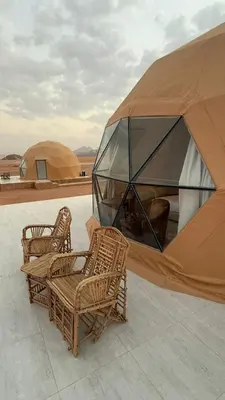 a group of wicker chairs and a dome tent at Harmony Luxury Camp in Wadi Rum