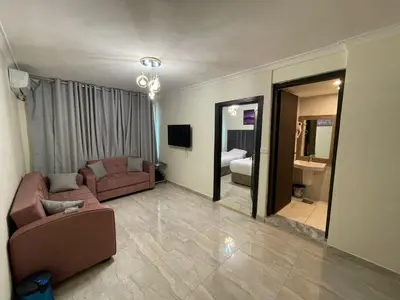 a large living room with a couch and a mirror at Golden Hotel in Amman