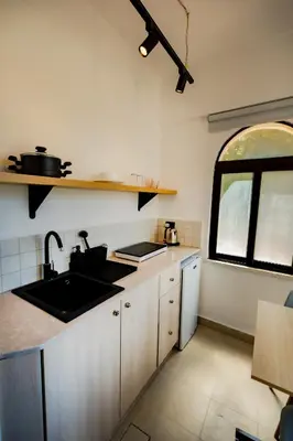 a kitchen with a sink and a window at Julia's Hotel Suites in Amman