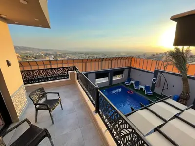 a balcony with a swimming pool on a building at Villa Jana Chalet in Ash Shāghūr