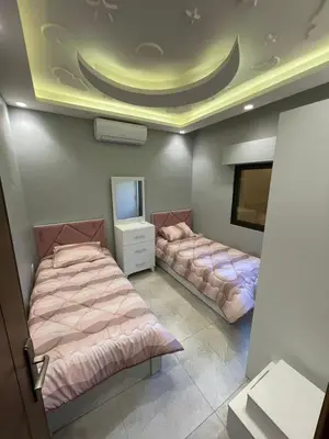 a room with two beds and a tv in it at Villa Jana Chalet in Ash Shāghūr