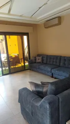 a living room with couches and a couch and a table at Villa Jana Chalet in Ash Shāghūr