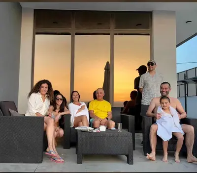 a group of people sitting in chairs on a patio at Follow Sea Villa in Sowayma