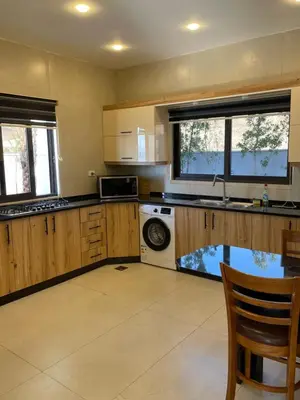 a kitchen with a sink and a dishwasher at Follow Sea Villa in Sowayma