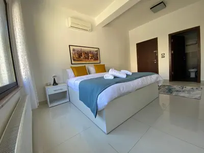 a bedroom with a bed with towels on it at Lemon Tree Residence in Amman