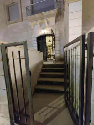 an entrance to a building with a gate and stairs at bedroom (3) apartment of 200 square meters with an outdoor terrace in Umm Uthainah