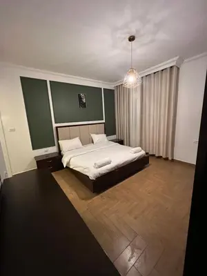 a bedroom with a bed and a chandelier at bedroom (3) apartment of 200 square meters with an outdoor terrace in Umm Uthainah