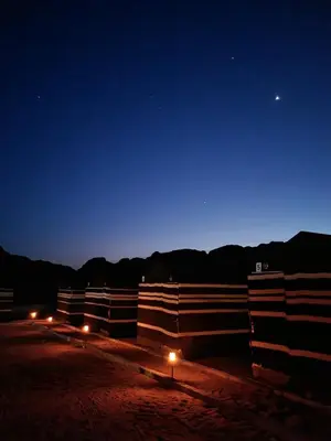 a barn at night with a blue sky at Wadi Rum Desert Heart Camp in Wadi Rum