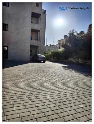 a car parked in front of a building at Weibdeh Heights Hotel Suites in Amman