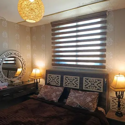 a bedroom with a bed and a mirror and a window at Top 