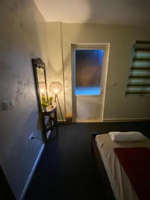 a bedroom with a bed and a mirror and a window at Hustle's look in Wadi Musa
