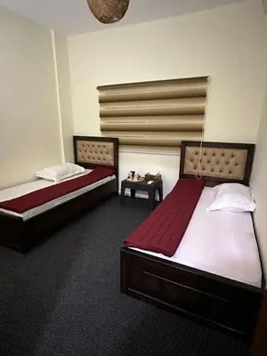 a room with two beds and a table in it at Hustle's look in Wadi Musa