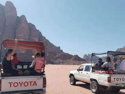 a group of people riding in the back of a truck at Rum desert camp in Wadi Rum