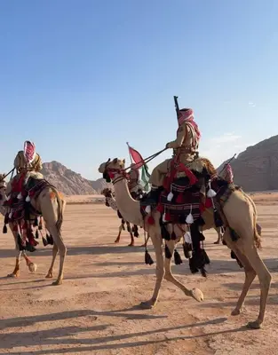 a group of men riding on camels in the desert at Rum Awaad luxury camp in Wadi Rum