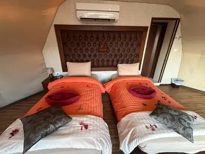 two beds sitting next to each other in a room at Rum Awaad luxury camp in Wadi Rum