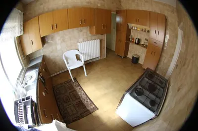 an overhead view of a kitchen with a white stove top oven at Alice & Andrew Apt. Few Steps to Madaba Old City Center in Madaba