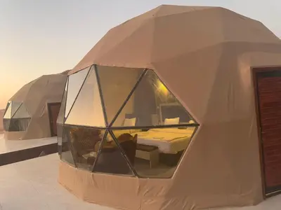 a large dome tent with a bed in it at Wadi Rum Aviva camp in Wadi Rum