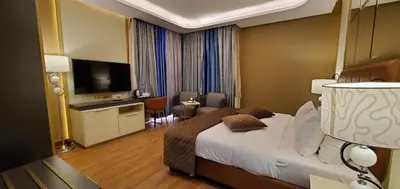 a hotel room with a bed and a television at Petra Moon Luxury Hotel in Wadi Musa