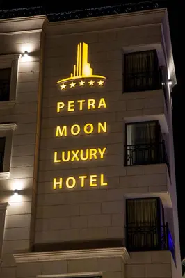 a hotel sign on the side of a building at Petra Moon Luxury Hotel in Wadi Musa