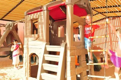 a group of children playing on a playground at Maria Beach Ground Floor Apartament in Aqaba