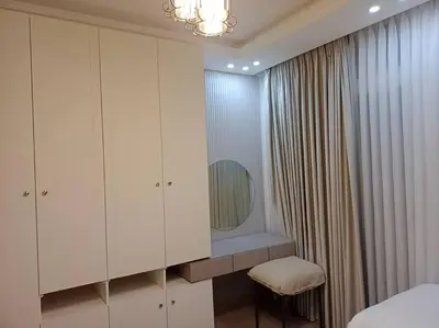 a bedroom with a bed and a mirror and a cabinet at Maria Beach Ground Floor Apartament in Aqaba