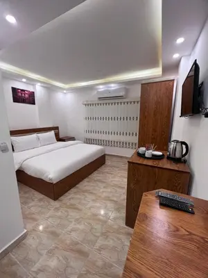 a bedroom with a bed and a desk with a keyboard at Petra Family Hotel in Wadi Musa