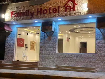 a family hotel with a sign on the side of a building at Petra Family Hotel in Wadi Musa