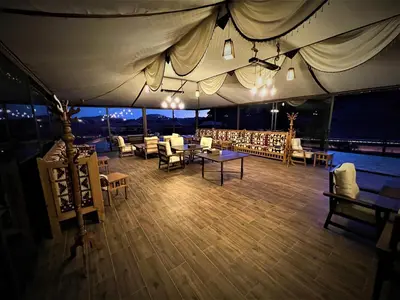 a large tent with tables and chairs on a boat at The Villas - Bedouin Boutique Resort in Wadi Rum