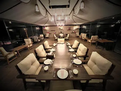 a large dining room with a long table and chairs at The Villas - Bedouin Boutique Resort in Wadi Rum