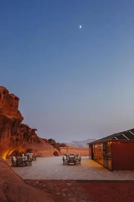 a group of tables and chairs in the desert at The Villas - Bedouin Boutique Resort in Wadi Rum