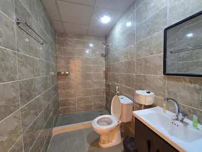 a bathroom with a toilet and a shower and a sink at Scarlet Luxury Camp Wadi Rum in Wadi Rum