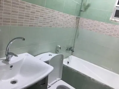 a bathroom with a sink and a toilet and a tub at Cozy House in Wadi Musa