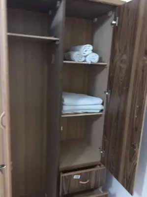 a wooden cabinet with towels and towels at Cozy House in Wadi Musa