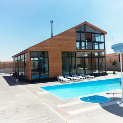 a house with a pool in front of it at The royal cottage Amman in Al Qasţal