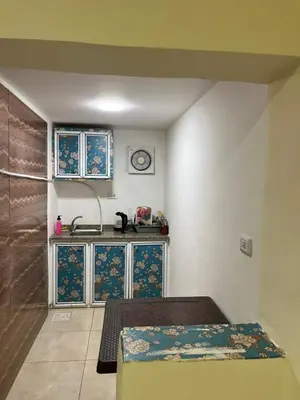 a small kitchen with a sink and a counter at Petra Main Gate Studios in Wadi Musa