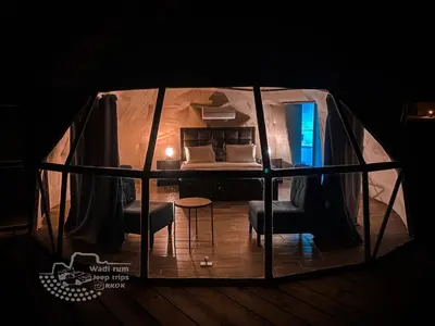 a room with a bed and two chairs in a tent at Rum Kingdom Camp in Wadi Rum