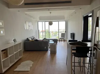 a living room with a couch and a table at Ronza Elegant Apartment in Amman