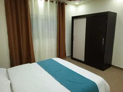 a bedroom with a bed and a sliding glass door at Petra Inn House in Wadi Musa