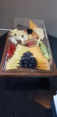 a tray of cheese and fruit on a table at Petra Inn House in Wadi Musa