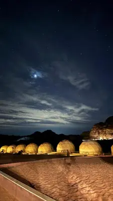 a group of domes in the desert at night at Wadi Rum Alia Luxury Camp in Wadi Rum