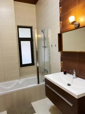 a bathroom with a sink and a shower and a tub at Contemporary Semi Villa Apartment with Private Entrance in Khalda in Amman