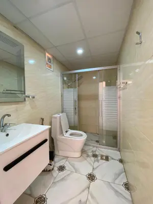 a bathroom with a toilet and a sink and a shower at Anwar Al Qamar Luxury Hotel in Wadi Rum
