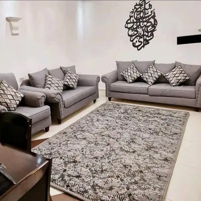 a living room with two couches and a rug at Pomegranate Tree in Wadi Musa