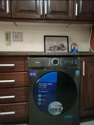 a kitchen with a washing machine in a kitchen at Pomegranate Tree in Wadi Musa