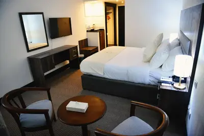 a hotel room with a bed and a table and chairs at Petra Castle Hotel in Wadi Musa