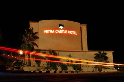 a building with aeria casa castle hotel at night at Petra Castle Hotel in Wadi Musa