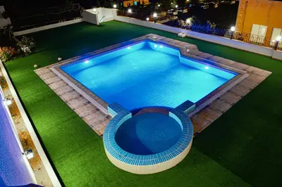 an overhead view of a swimming pool at night at Petra Castle Hotel in Wadi Musa