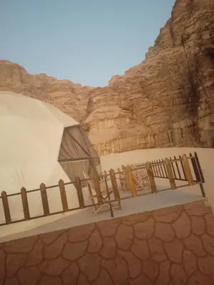 a building in the desert with a fence at Wadi rum desert sky in Wadi Rum