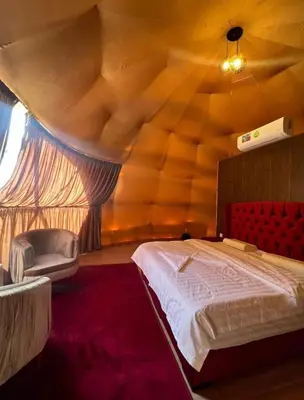 a bedroom with a bed in a room with a wooden ceiling at Wadi rum desert sky in Wadi Rum