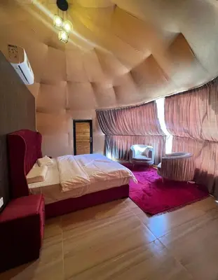 a bedroom with a bed in a room with a wooden ceiling at Wadi rum desert sky in Wadi Rum